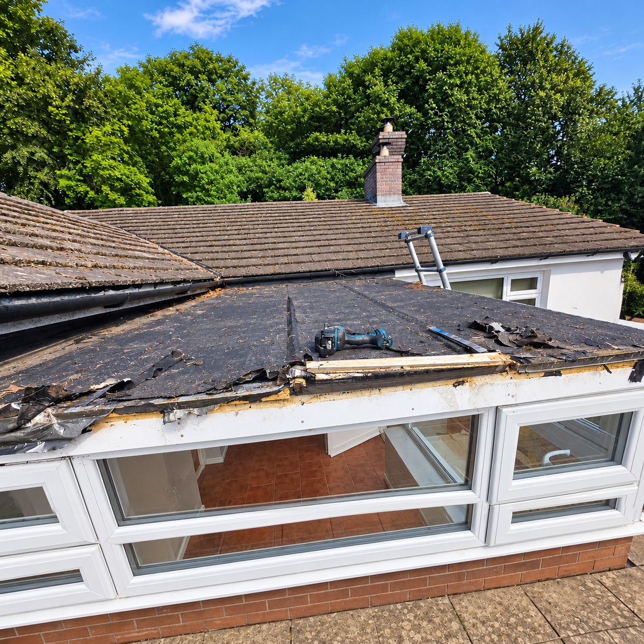 Old flat conservatory roof being stripped back