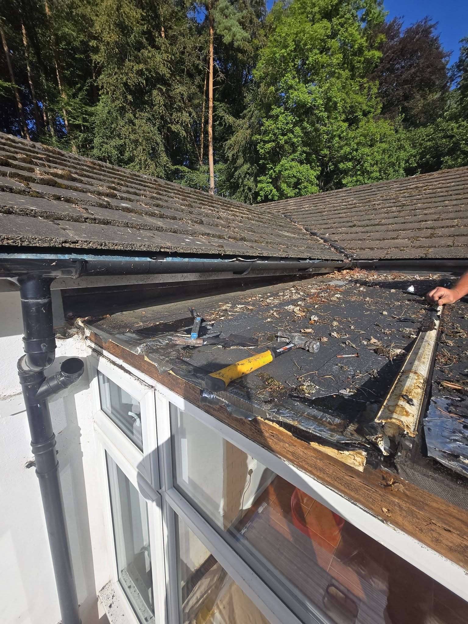 Roofing work beside an existing tiled roof